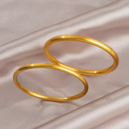 Brazalete abierto de acero inoxidable pulido chapado en oro
