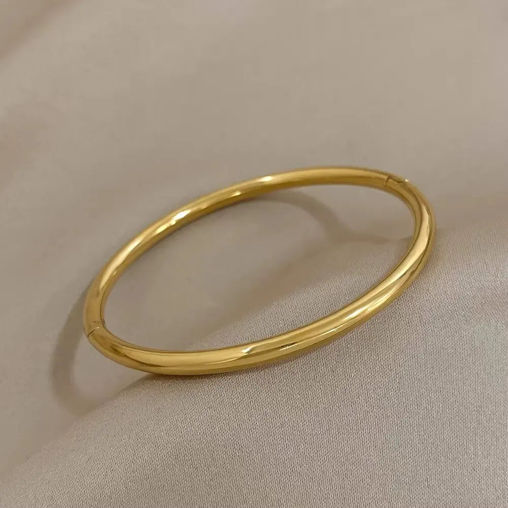 Brazalete abierto de acero inoxidable pulido chapado en oro