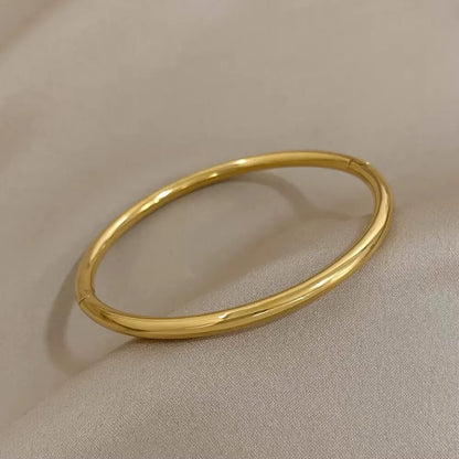 Brazalete abierto de acero inoxidable pulido chapado en oro