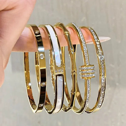 Brazalete abierto de acero inoxidable pulido chapado en oro
