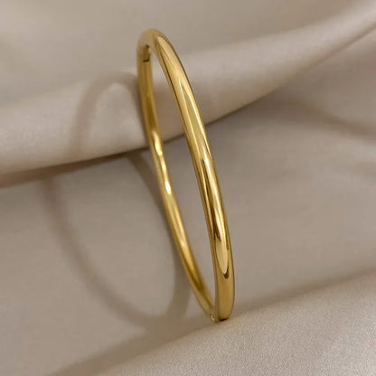 Brazalete abierto de acero inoxidable pulido chapado en oro