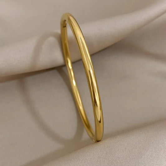 Brazalete abierto de acero inoxidable pulido chapado en oro